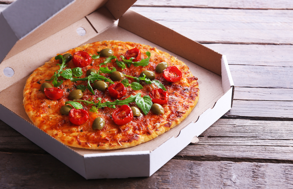 Pizza,In,Box,On,Wooden,Table,,Closeup