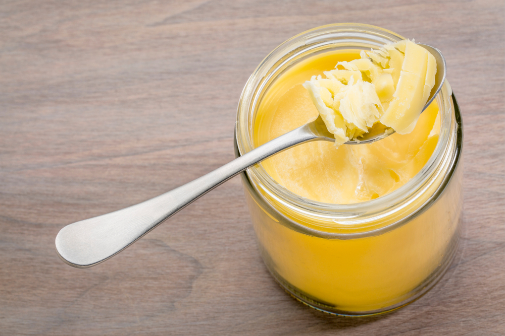 Jar,And,Tablespoon,Of,Ghee,(clarified,Butter),On,Grained,Wood