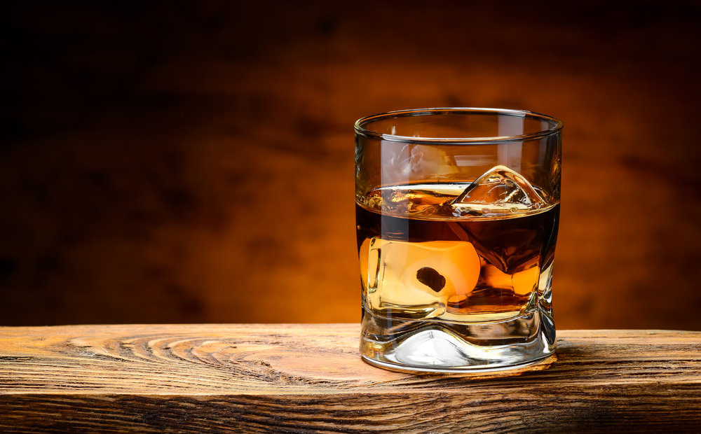 Whiskey,With,Ice,On,A,Wooden,Table