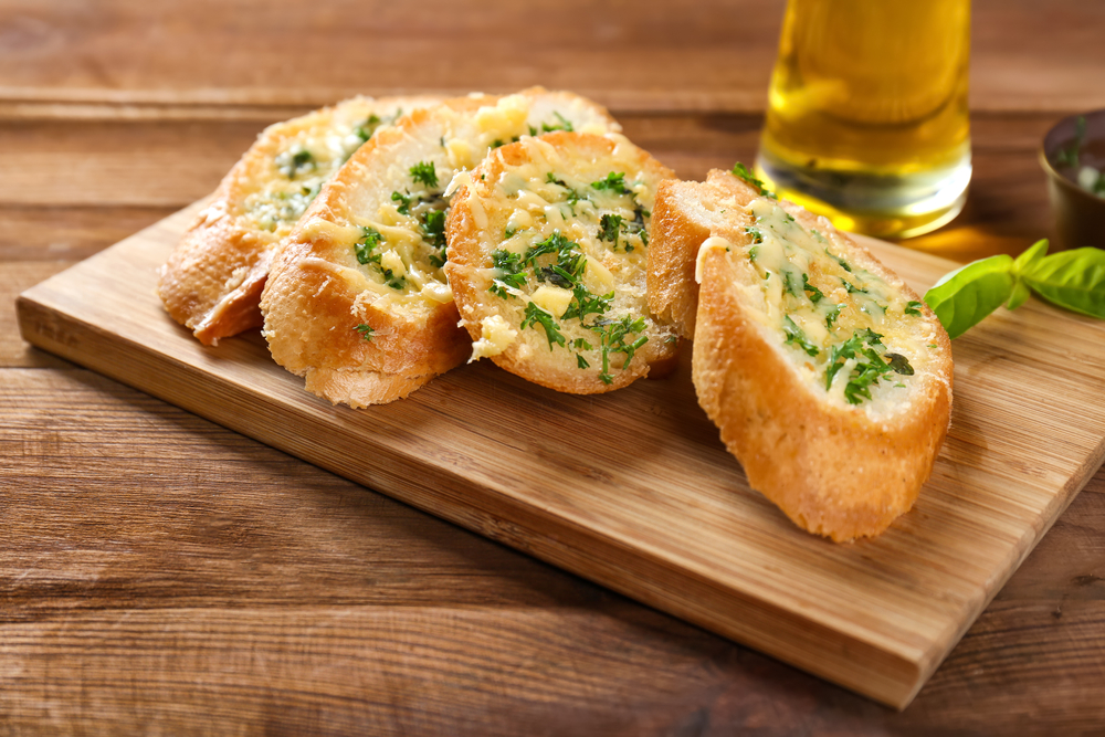 Tasty,Bread,With,Garlic,,Cheese,And,Herbs,On,Kitchen,Table
