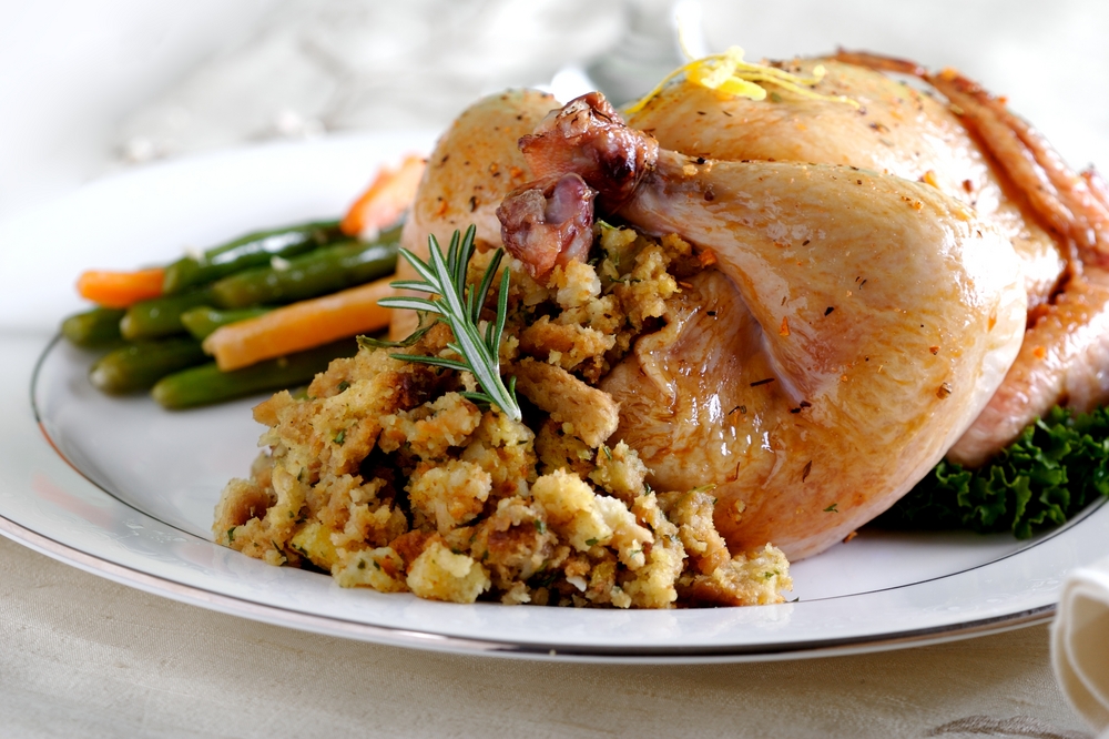 Cornish,Hen,With,Stuffing,And,Beans,On,A,White,Background.