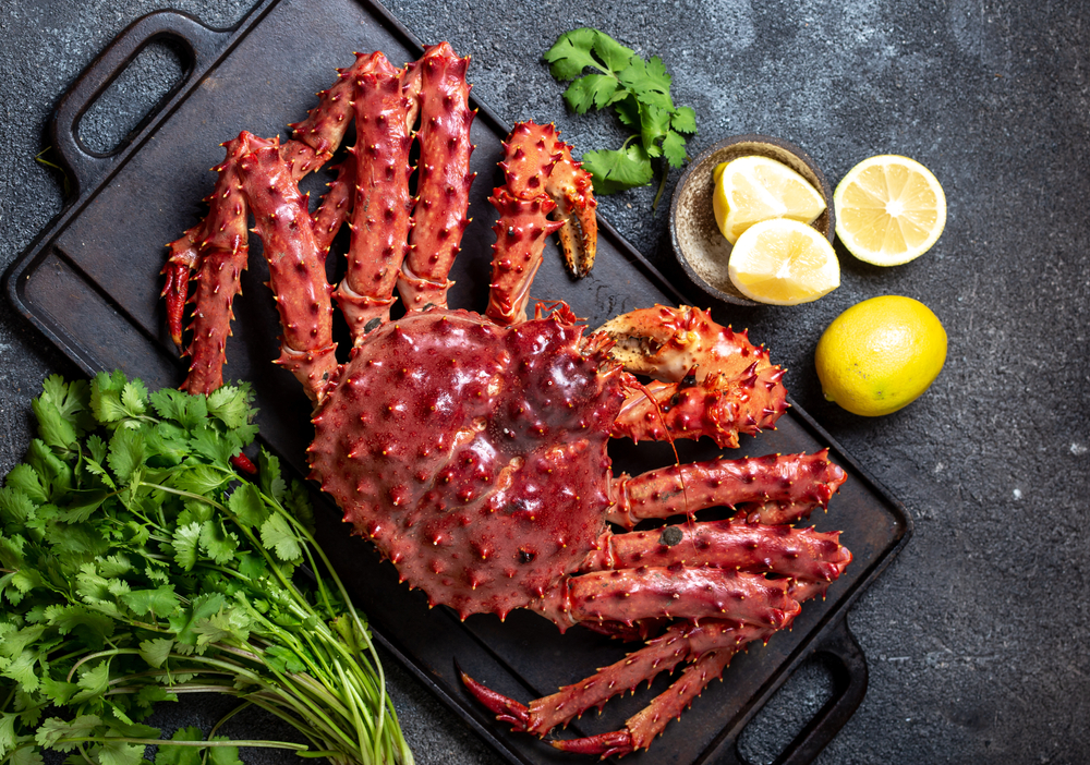 King,Crab,With,Lemon,And,Cilantro,On,Black,Background.,Top