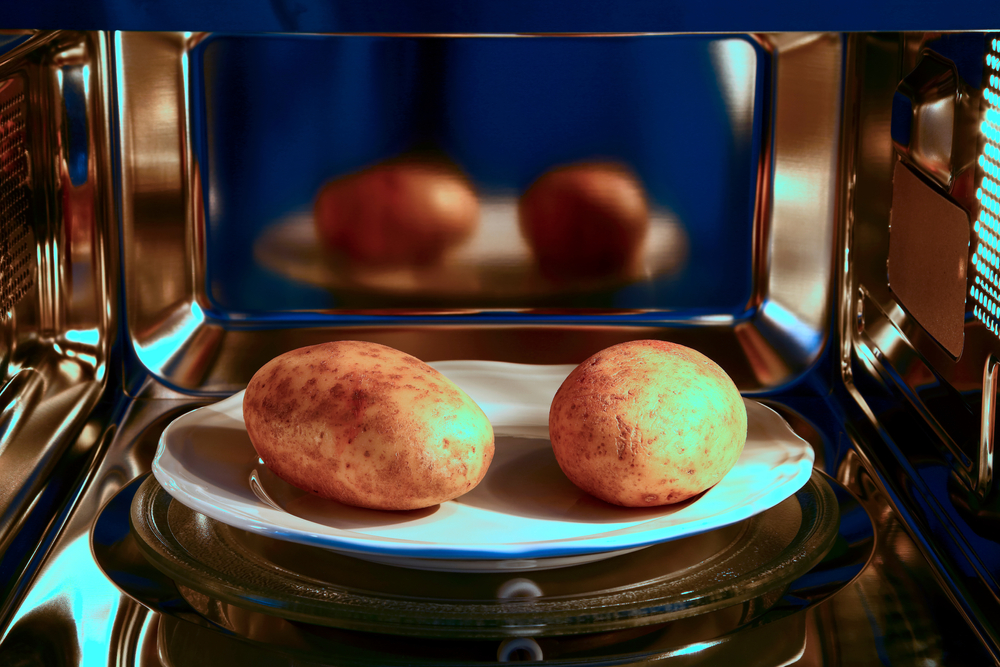 Two,Baked,Potatoes,Ready,To,Cook,In,A,Microwave,Oven