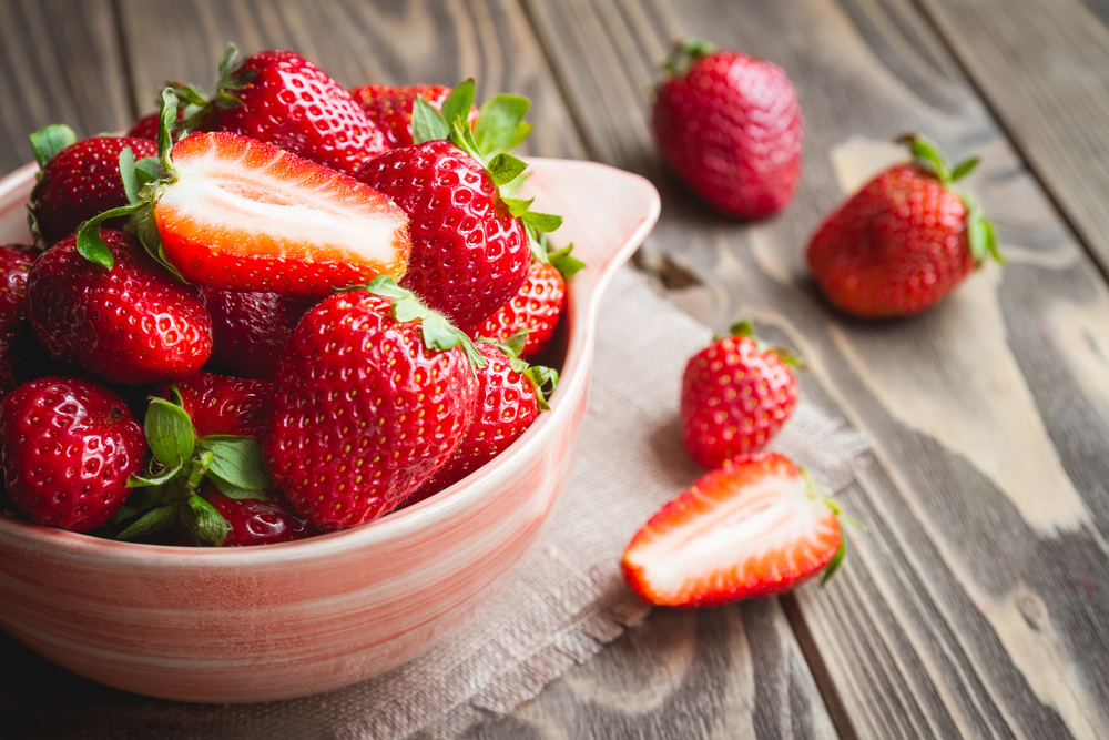 Fresh,Strawberries,In,A,Bowl,On,Wooden,Table,With,Low