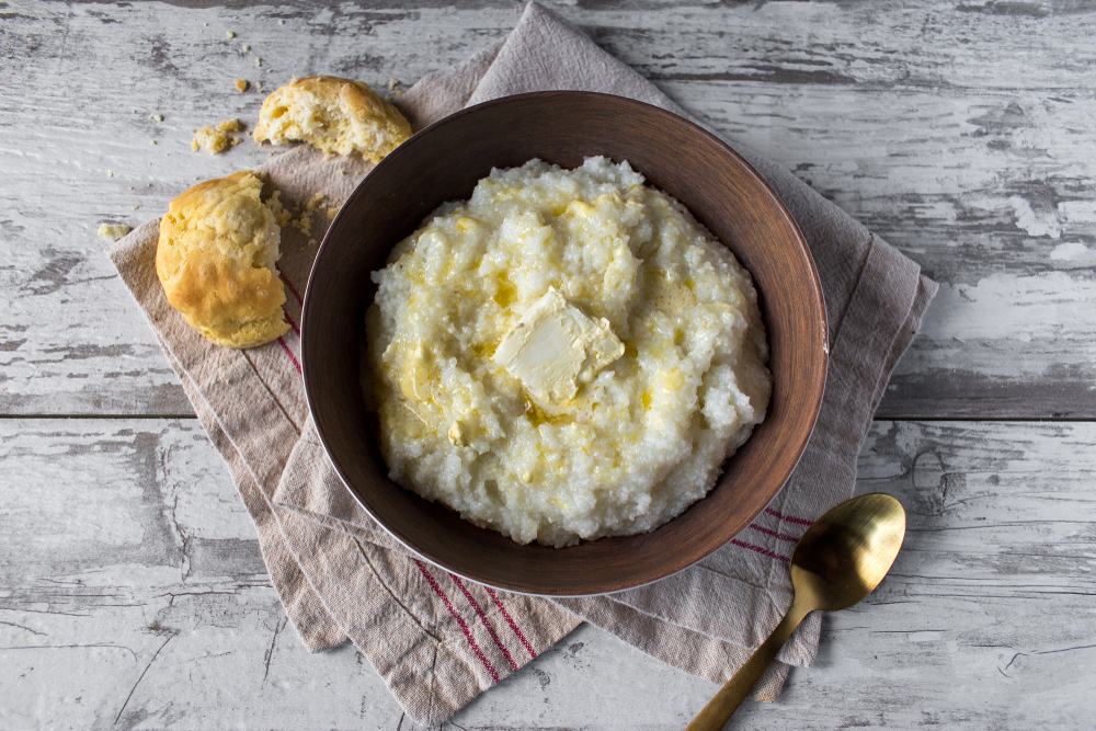 Buttered,Grits,With,Biscuits,In,Rustic,Setting,Top,View