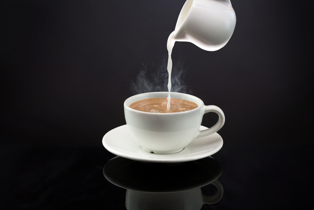 Pouring,A,Milk,In,To,A,Mug,Of,Hot,Coffee