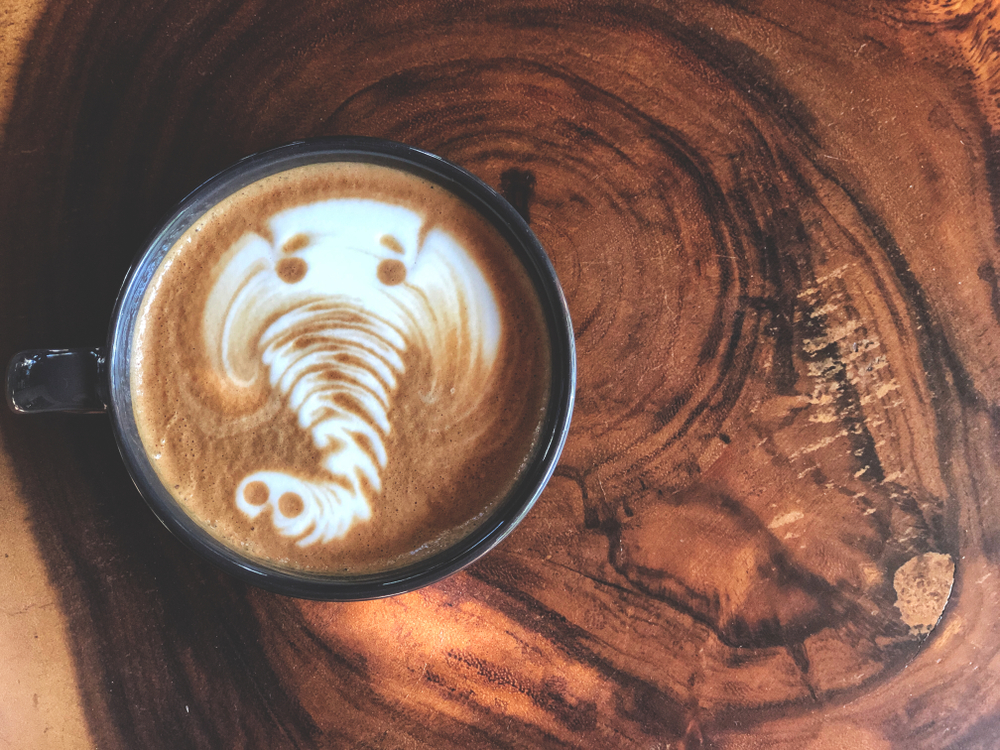 Elephant,Latte,Art,Coffee,In,Black,Cup,On,Vintage,Wooden