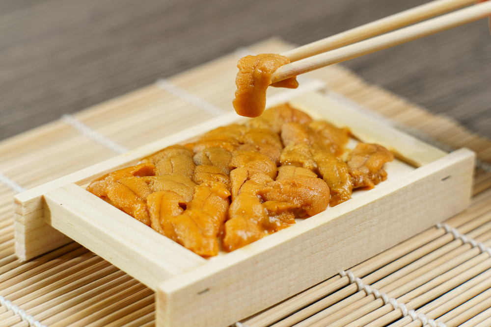Uni,Sushi,In,Chopsticks.,Sea,Urchin(uni,Sashimi),,japanese,Food.