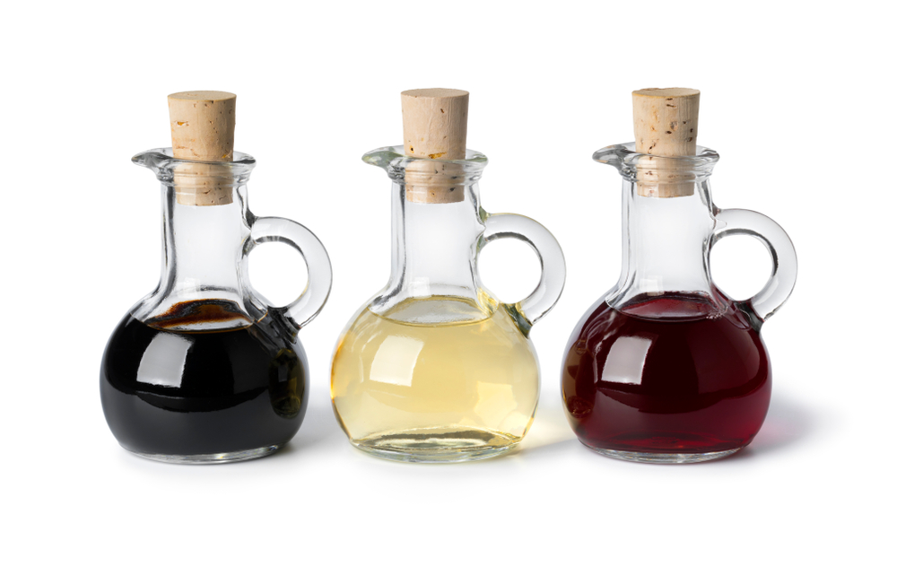 Three,Glass,Bottles,With,Different,Types,Of,Vinegar,Isolated,On