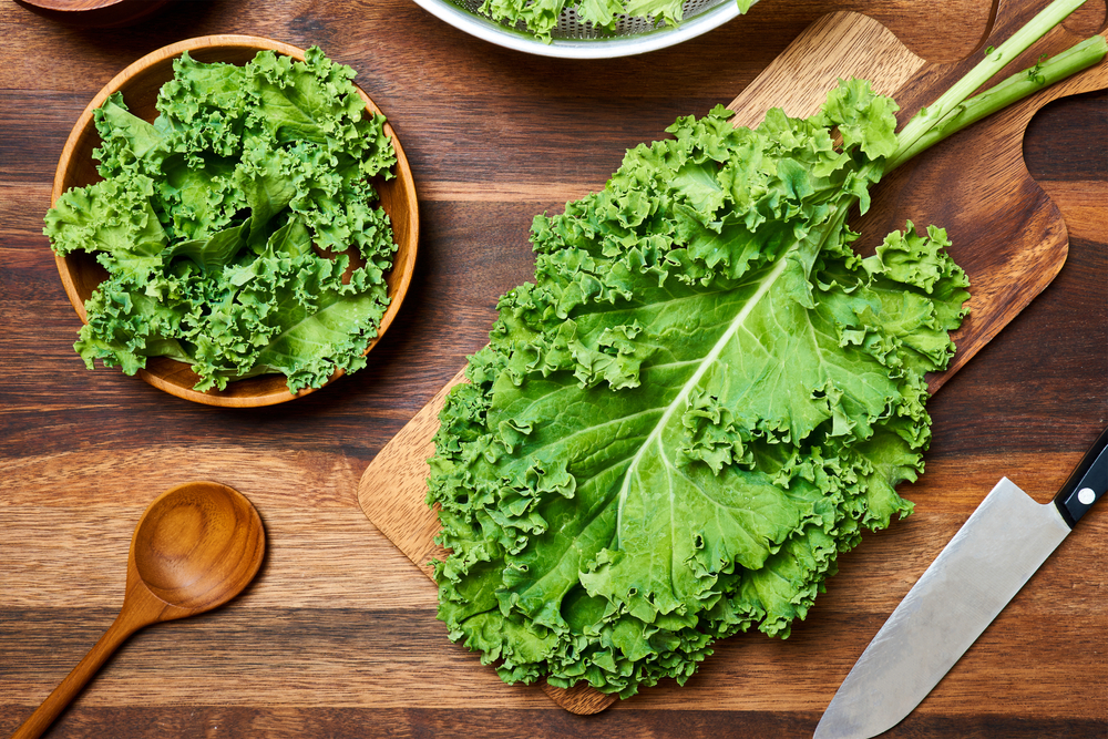 Concept,Of,Fresh,Kale,Leaves,Salad,On,Wooden,Table,Background.