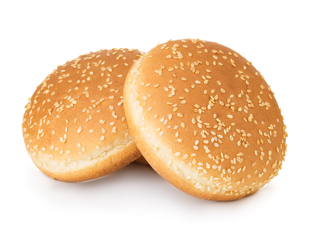 Two hamburger buns with sesame isolated on white background.