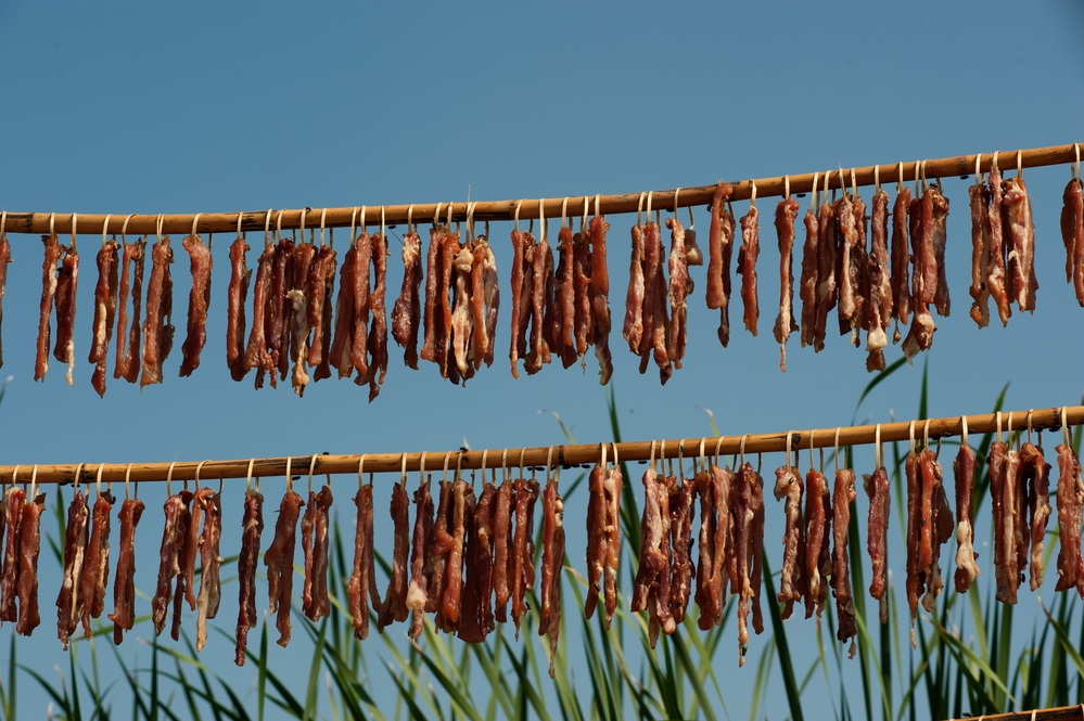 Meats drying in the sun .