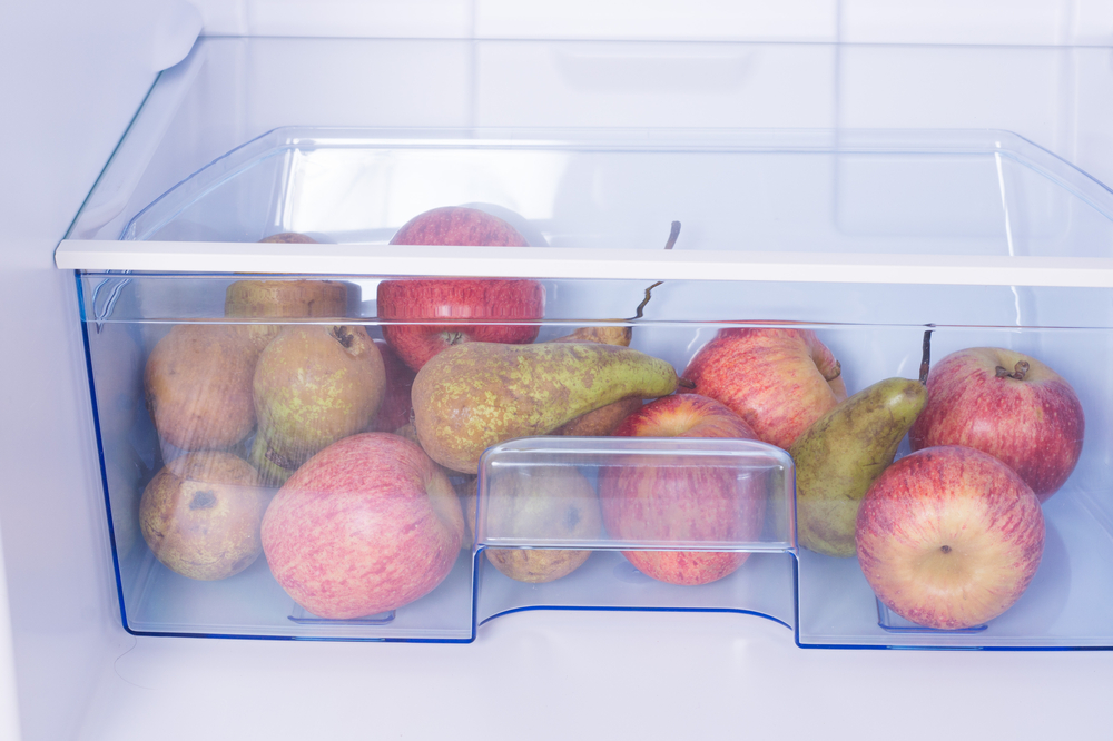 Open fridge, apples and pears on the shelf of refrigerator, healthy nutrition concept