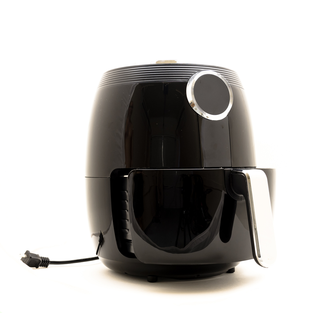 Close-up air fryer kitchen appliance with power cord isolated on