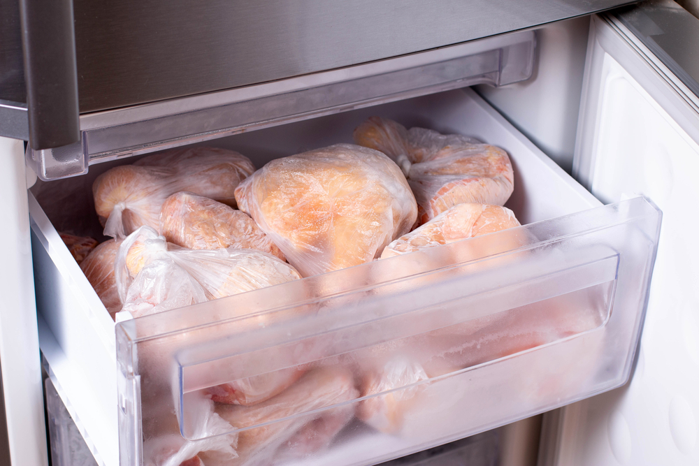 Frozen meat in bags on the freezer shelf